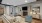 Resident lounge at our apartments for rent in Charleston, SC, featuring wood grain floor paneling and tables with chairs.
