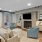 Resident lounge at our apartments for rent in Charleston, SC, featuring wood grain floor paneling and tables with chairs.