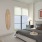 Model bedroom at our apartments for rent in Charleston, SC, featuring wood grain flooring and large windows.